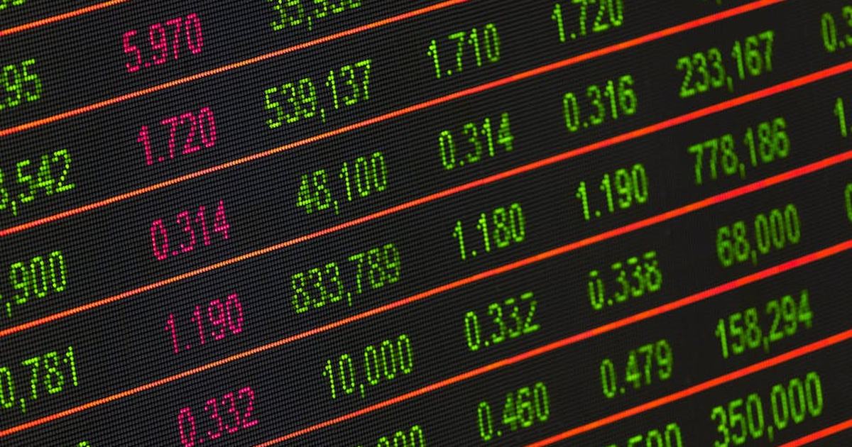 Close-up of a digital stock market data display showing colorful financial numbers and trends.