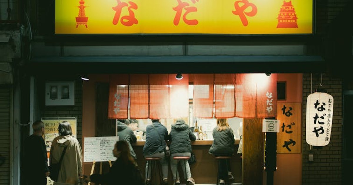 Intimate view of a ramen shop in Tokyo at night, with patrons enjoying their meal.