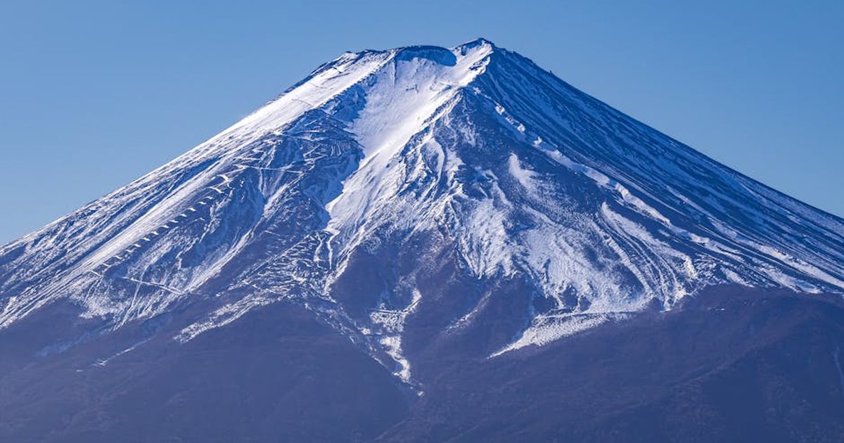 Stunning view of Mount Fuji with snow, captured on a clear day in Fujiyoshida, Japan.