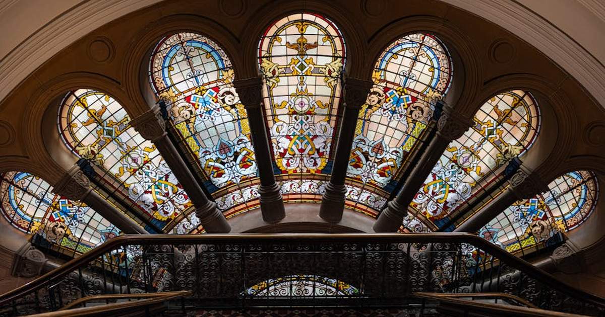 Colorful stained glass ceiling in historic Sydney building captures intricate architectural beauty.