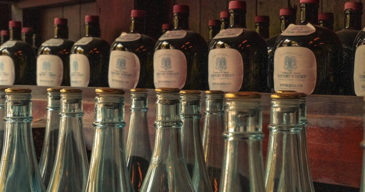 Rows of vintage whisky bottles create a warm, classic atmosphere in a Tokyo bar.