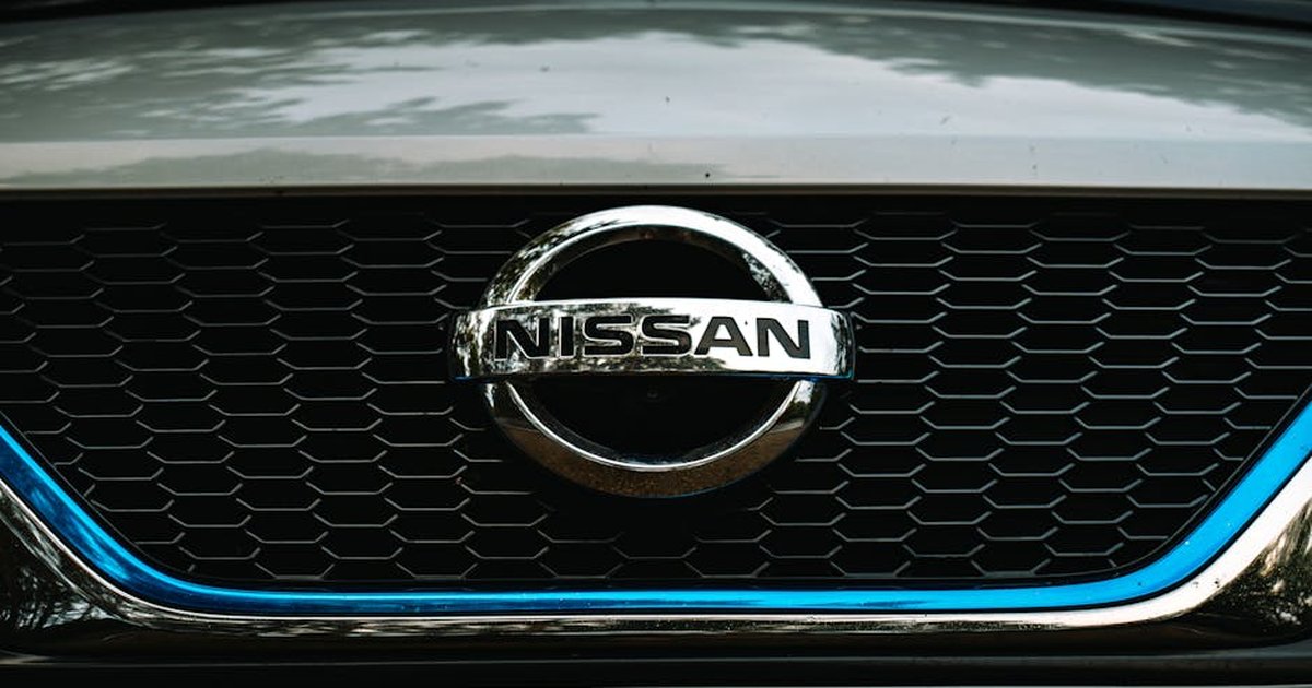 Detailed view of a car brand logo on the front grille, showing intricate design and texture.