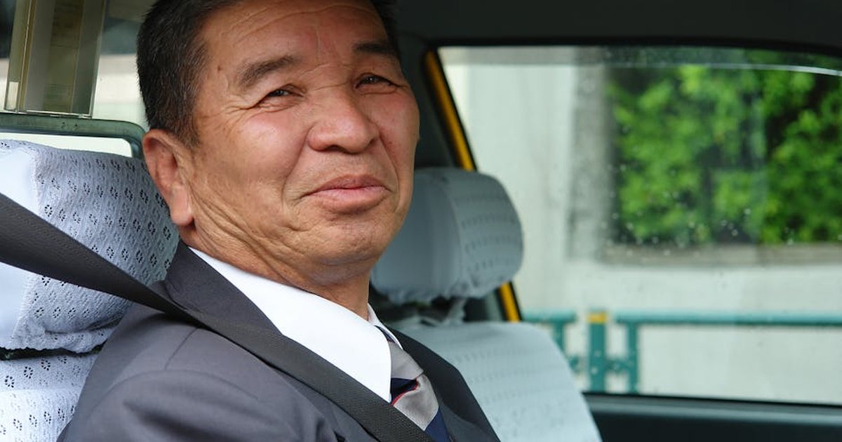 Friendly taxi driver in Tokyo, Japan, showcasing urban transportation and hospitality.