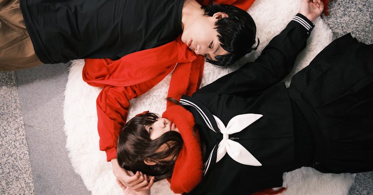 Couple in cosplay costumes embracing on a warm rug. Showing affection and togetherness.