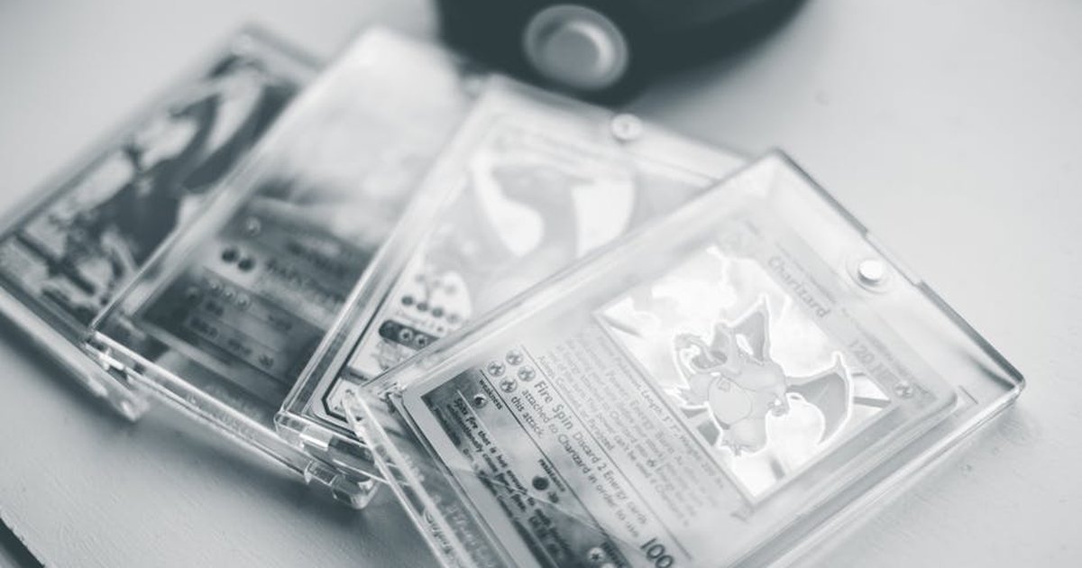 Close-up of collectible Pokemon cards in protective cases, emphasizing preservation and value.