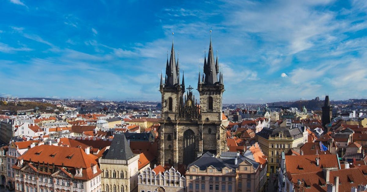 Explore the breathtaking aerial view of Prague with its historic church spires and charming rooftops.