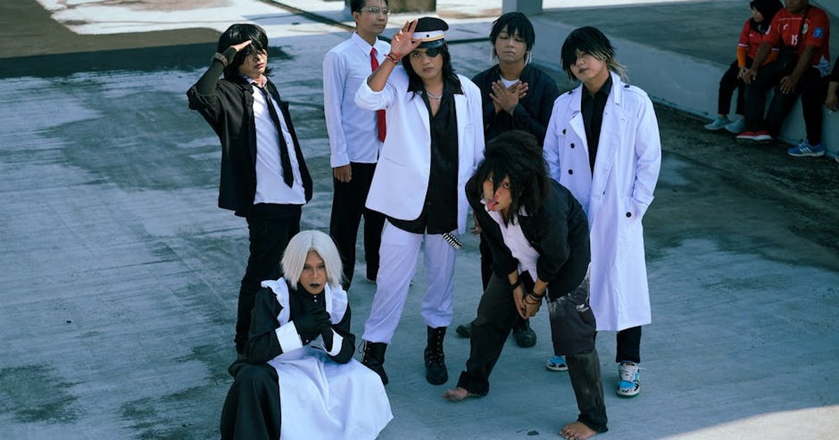 Young adults in creative cosplay outfits posing outside, showcasing unique fashion and expressions.