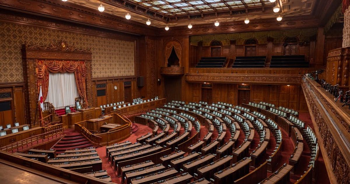 Captivating wide-angle view of a classic legislative assembly hall with ornate wood design.