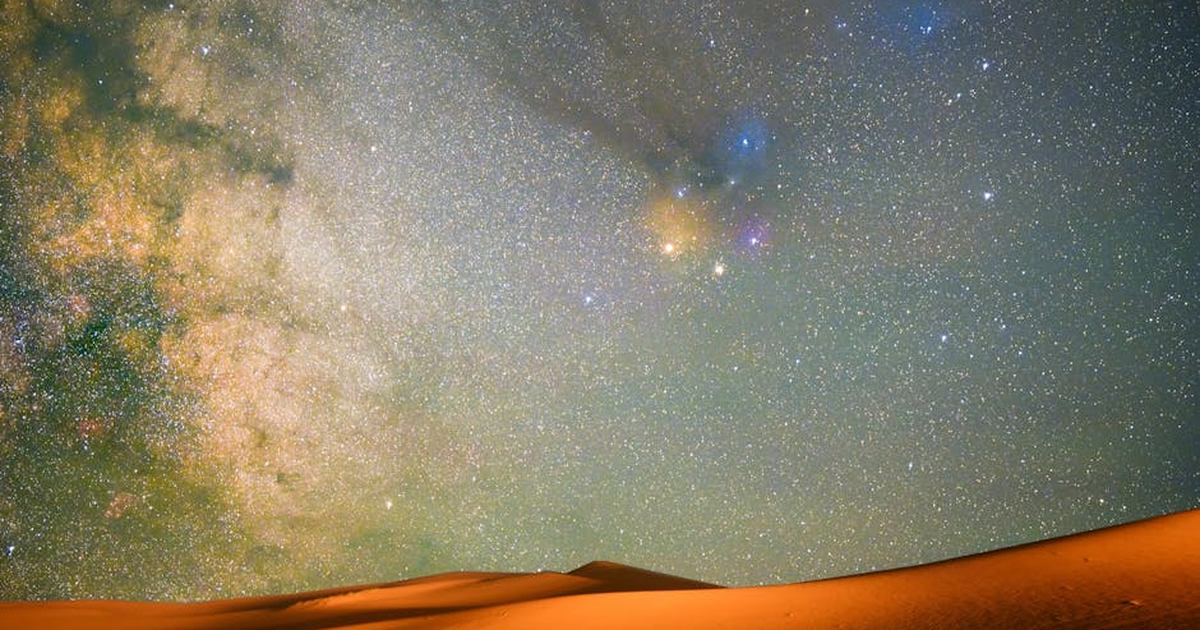 Captivating view of a starry night sky above sand dunes in Inner Mongolia, China.