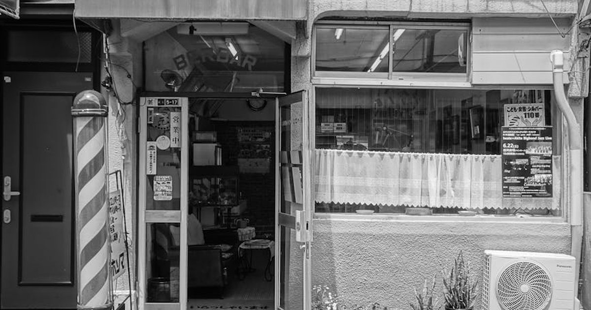 Explore a classic barber shop's facade in Morioka, Japan, highlighted in grayscale photography.