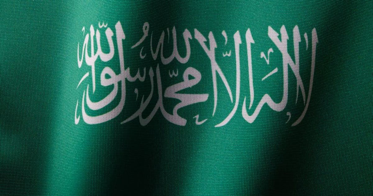 Detailed close-up of the Saudi Arabian flag showcasing the elegant Arabic script and vibrant green color.