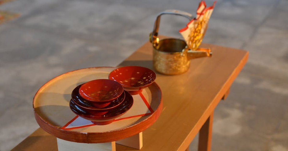 A serene display of traditional Japanese tea ceremony utensils on a wooden table, capturing elegance in simplicity.