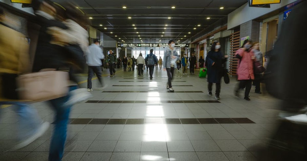 Crowds of people rushing through Taipei City Station, capturing urban life and daily commute.