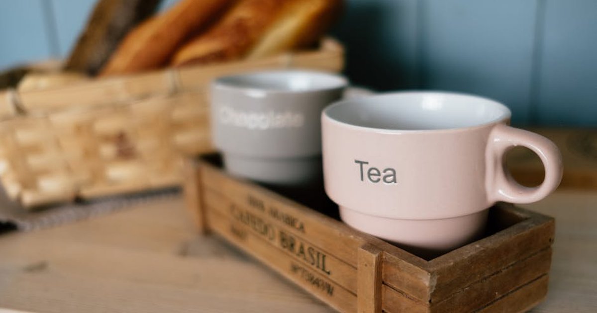 Cozy still life with ceramic cups labeled tea and chocolate, perfect for breakfast imagery.