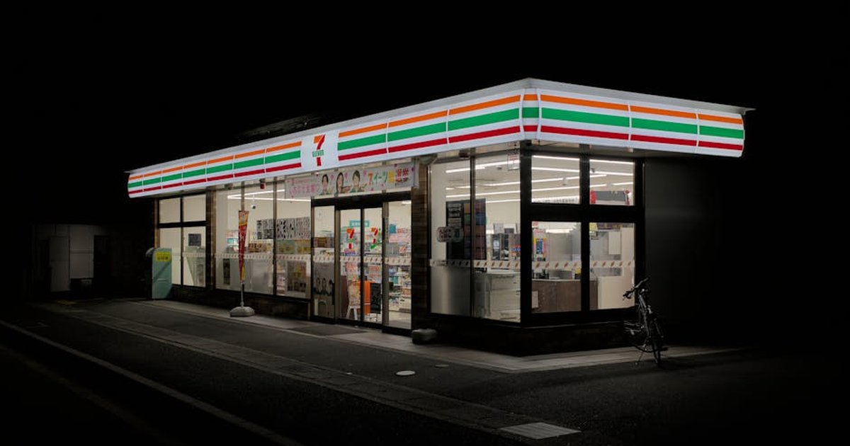 A brightly lit convenience store in Kyoto, Japan, at night.