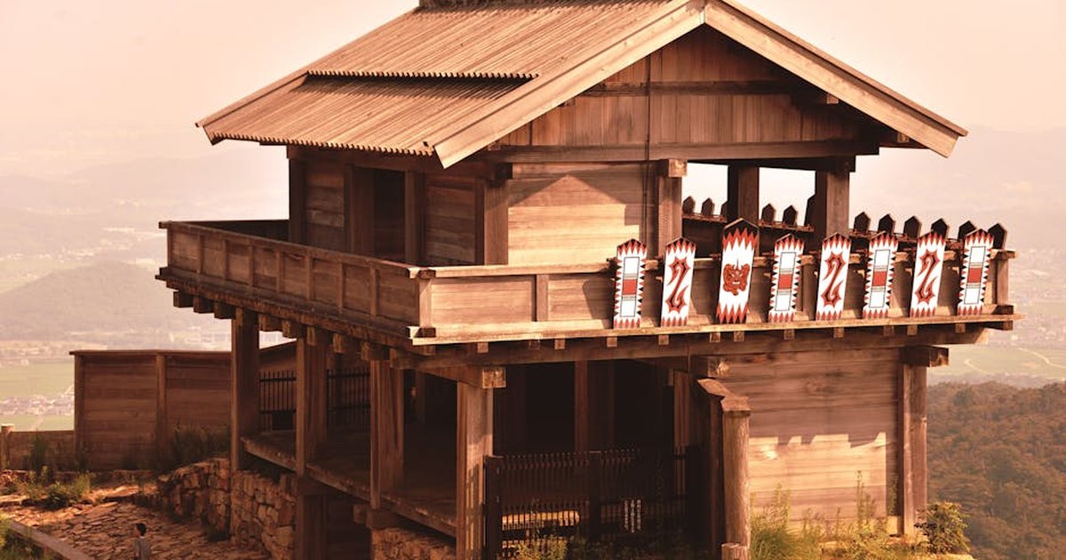 Explore the serene traditional Japanese wooden temple on a hill, capturing historic architecture and culture.
