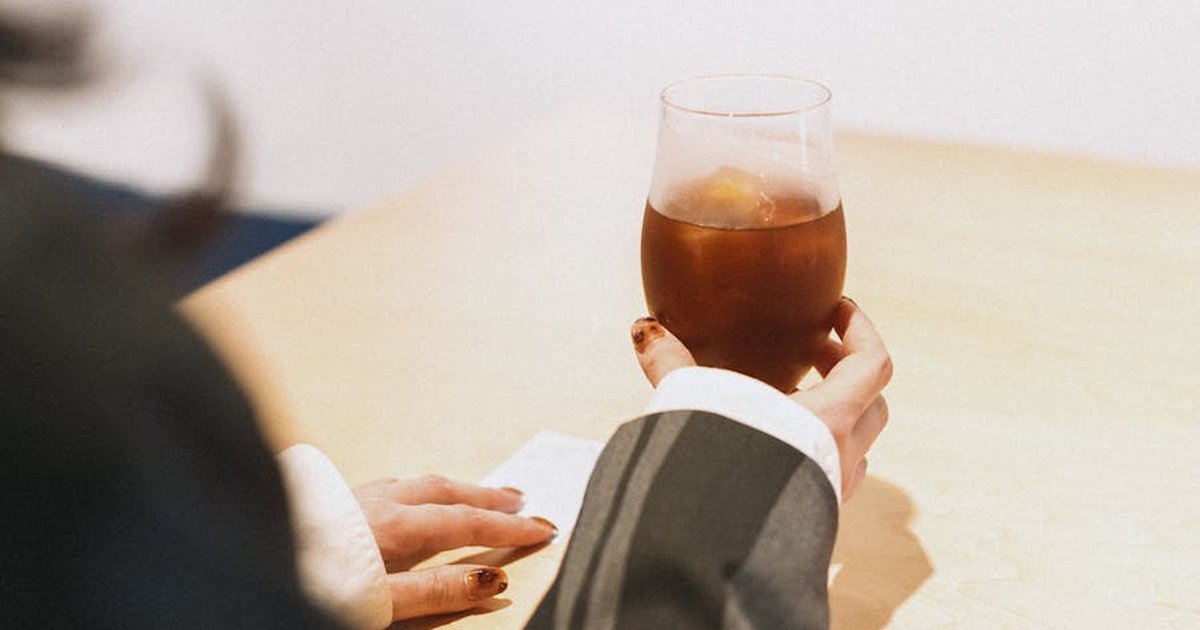 A stylish adult enjoying a cold drink in a modern setting. Perfect for lifestyle imagery.