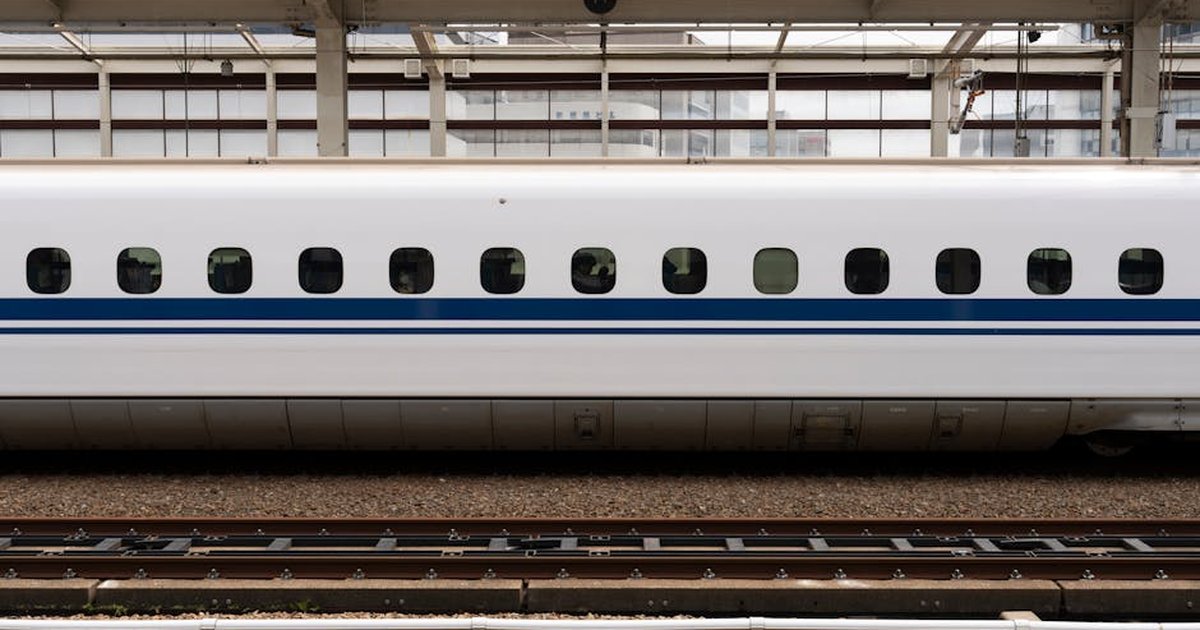 High-speed bullet train on a platform at Osaka Station, showcasing modern transportation.