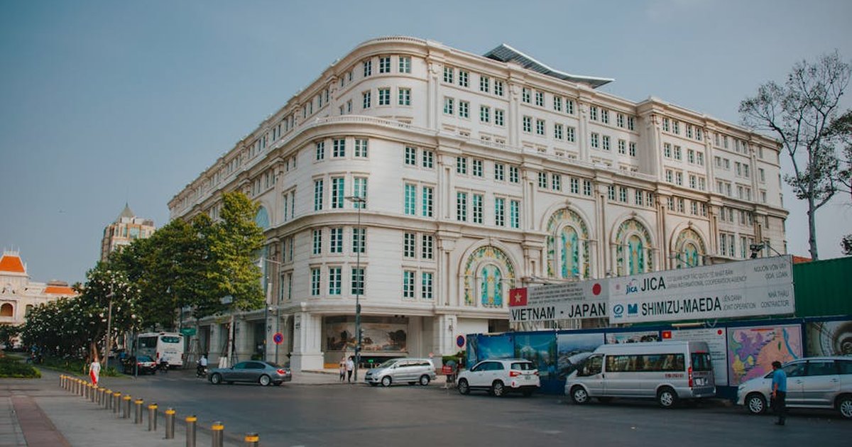 Elegant colonial-style building on a city street in Ho Chi Minh City, Vietnam.