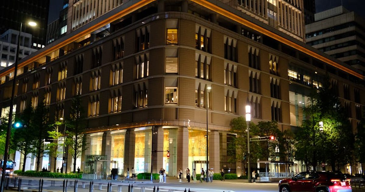 Contemporary architecture of Marunouchi at night in Tokyo, Japan, with urban activity.