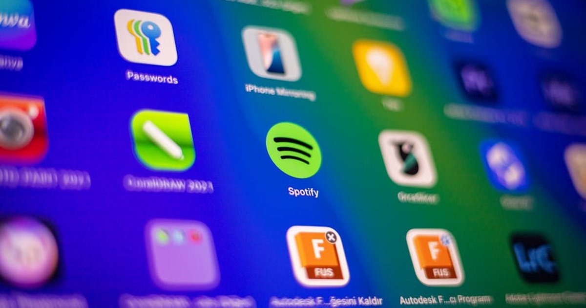 Blurred close-up of vibrant app icons on a smartphone screen showcasing Spotify and more.