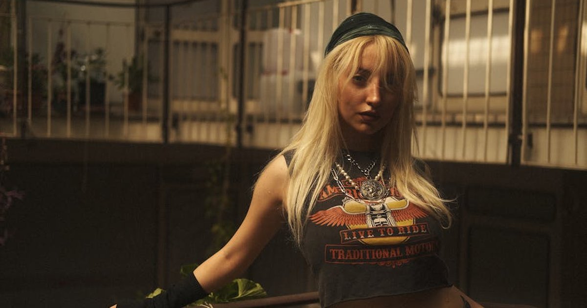 Fashionable woman in a vintage setting with edgy attire and accessories.