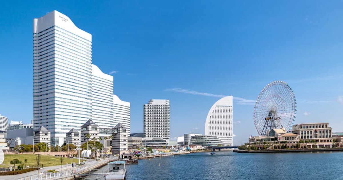 Experience Yokohama's modern skyline featuring skyscrapers and a giant Ferris wheel by the bay.
