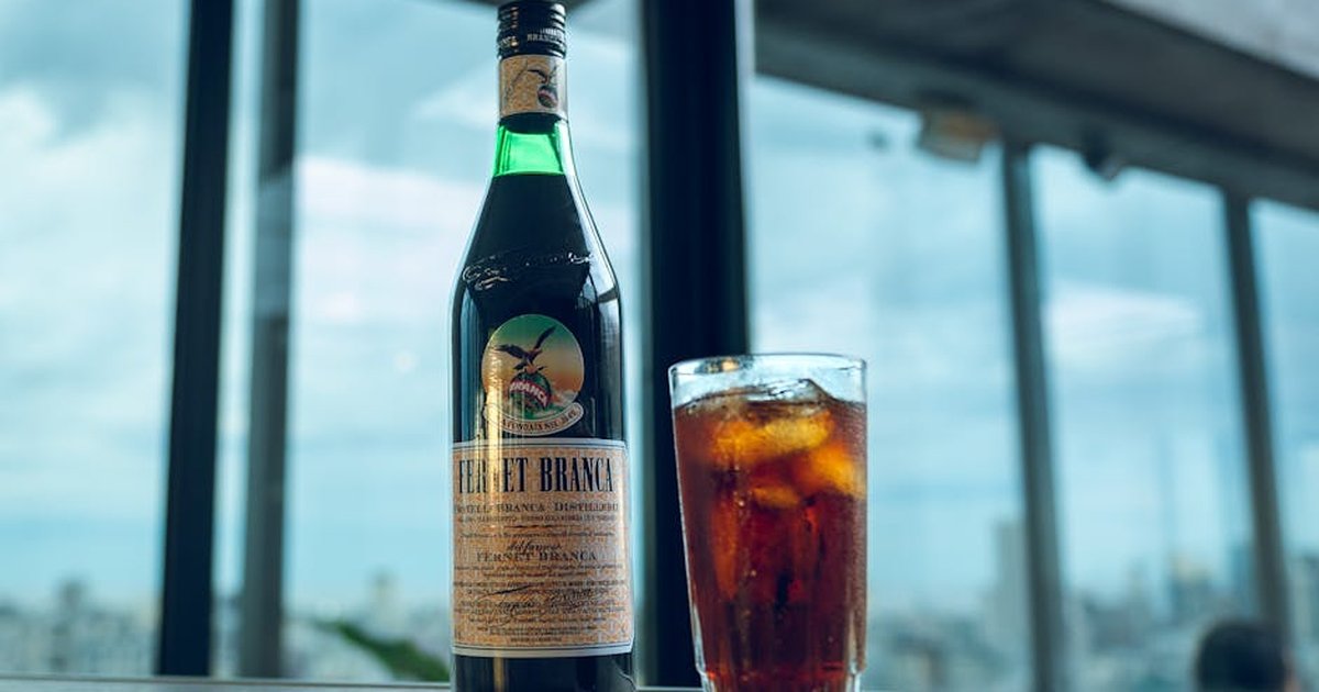 Fernet Branca bottle with a refreshing iced drink on a café terrace in Buenos Aires, Argentina.