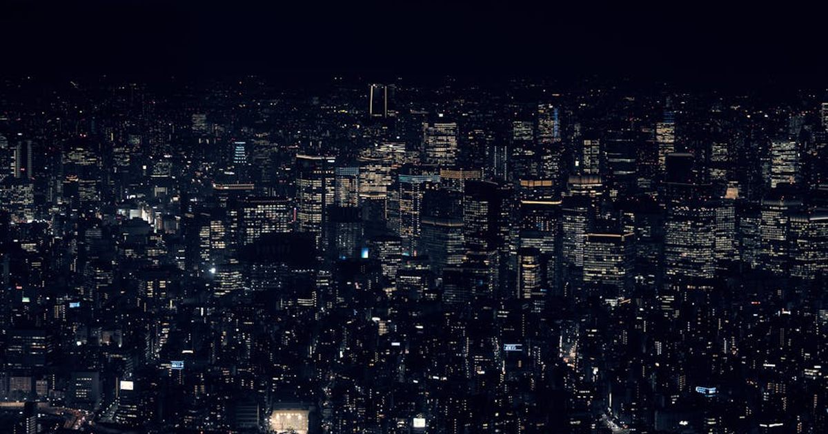 A stunning view of Tokyo's cityscape with illuminated skyscrapers at night, showcasing urban life in Japan.