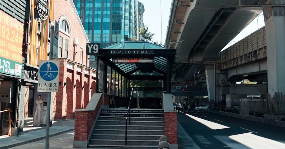 View of Taipei City Mall entrance Y9, surrounded by modern architecture and elevated roads in Taipei, Taiwan.