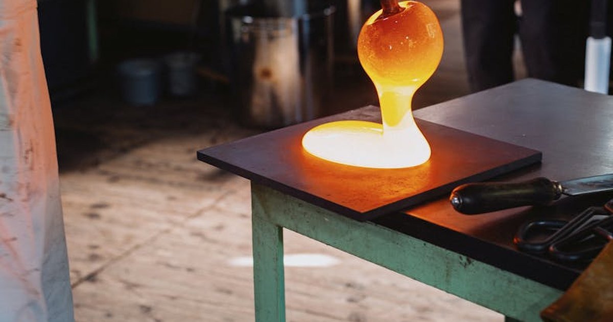 Hot glass being shaped in a workshop in Nagano, Japan. Close-up view of traditional glassblowing process.