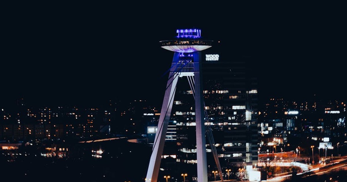 Stunning night view of the UFO Observation Deck in Bratislava, Slovakia, showcasing the city's vibrant skyline.