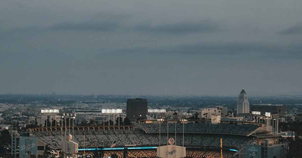 A stunning aerial view of Dodger Stadium in Los Angeles at dusk, showcasing the vibrant urban landscape.