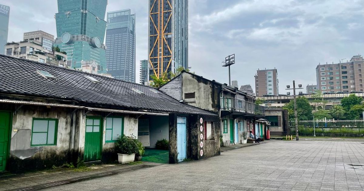 A scene showcasing urban skyscrapers alongside traditional buildings in Taipei, Taiwan.