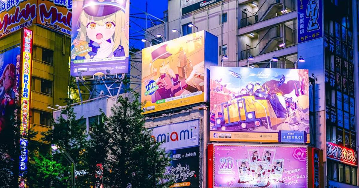 Bright anime billboards illuminate the night in Akihabara, Tokyo, showcasing the vibrant nightlife.