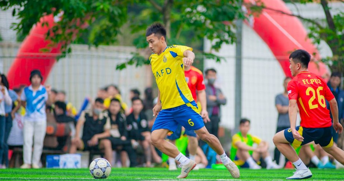 A dynamic soccer game captured in Hanoi, showcasing players in action on a vibrant field.