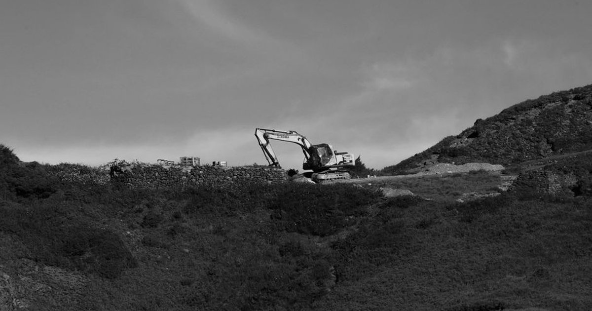 Black and white photo of an excavator on a mountain in Nantou County, Taiwan.