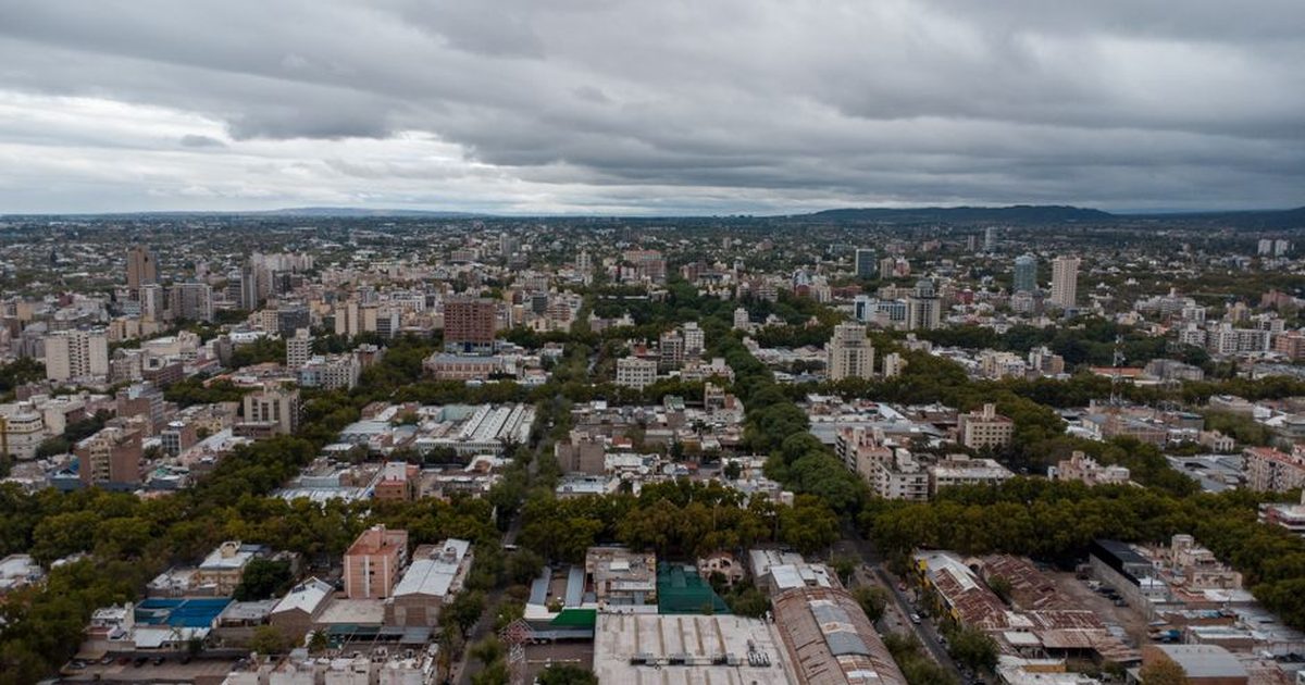 Discover a stunning aerial view of Mendoza City, showcasing urban landscapes amidst lush greenery.