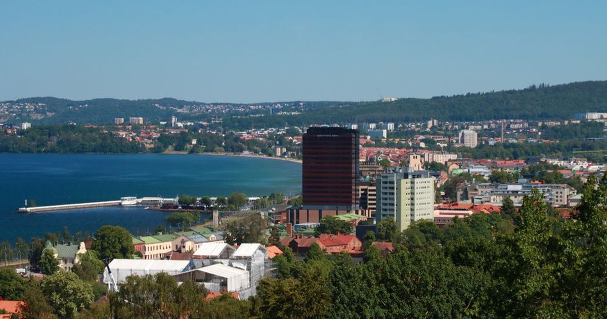 A scenic aerial view of Jönköping, Sweden with Vättern Lake and lush greenery during a bright summer day.