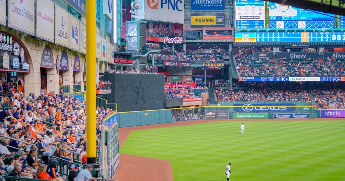 Vibrant baseball game scene with a full stadium, cheering crowd, and bright advertisements.
