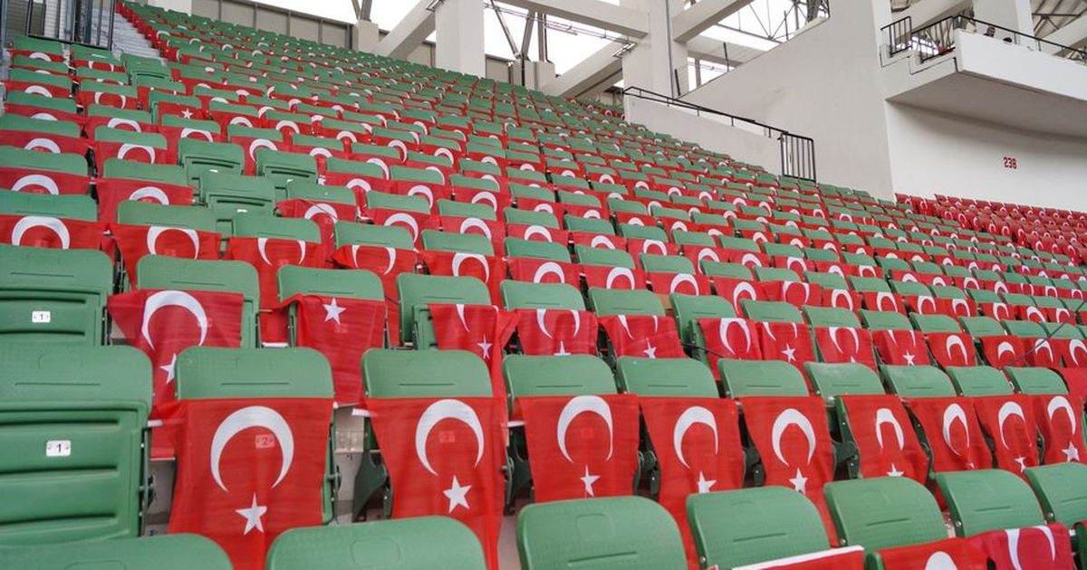 Rows of stadium seats draped with Turkish flags, symbolizing patriotism.
