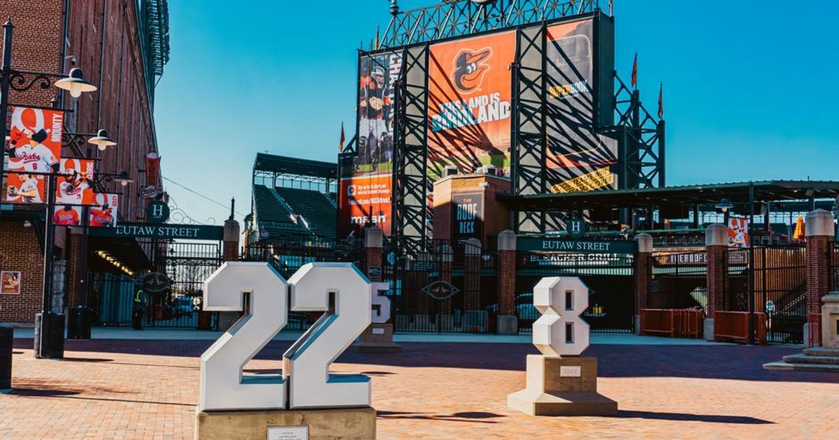 View of Eutaw Street entrance at Camden Yards adorned with Baltimore Orioles signage and team monuments.