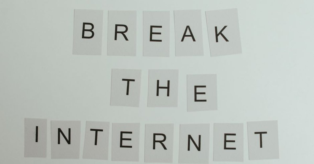 Conceptual image with text 'Break the Internet' using letter cards on a light background.