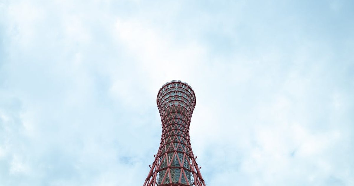 From below of high metal Kobe Port Tower landmark of Japan under cloudy sky