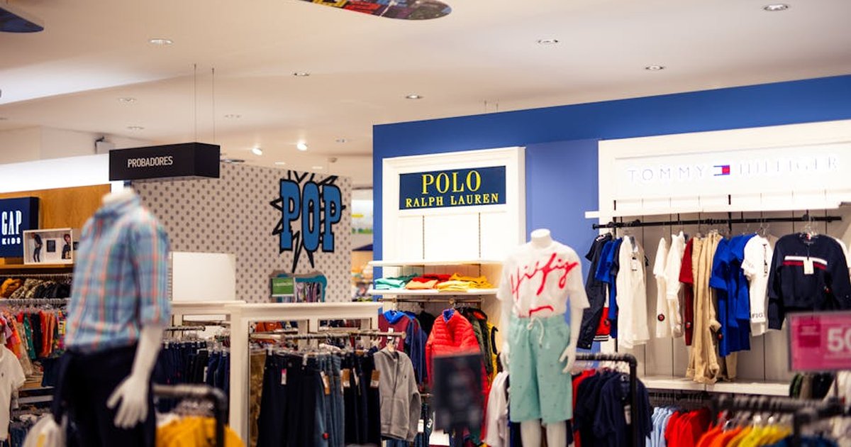 Vibrant clothing display at a modern retail store with mannequins featuring popular fashion brands.