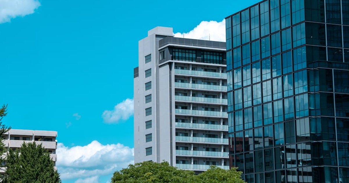 Modern buildings in Tokyo against a bright blue sky, showcasing contemporary urban architecture.