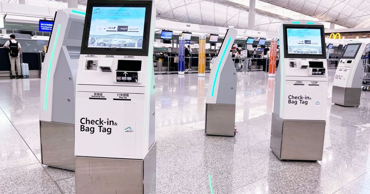 Modern check-in kiosks at Hong Kong International Airport's terminal. Efficient travel is enhanced by technology.