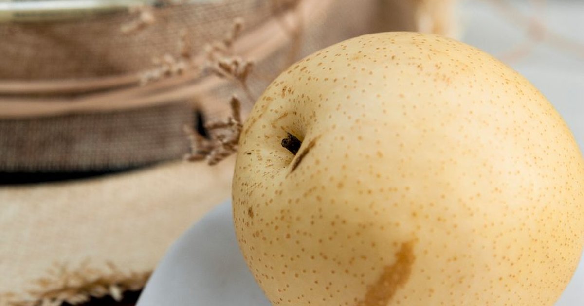 Detailed close-up of a fresh Pear, highlighting texture and natural setting.