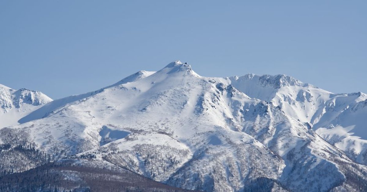 Explore the serene beauty of the snow-capped Asahi-Dake in Hokkaido, Japan.