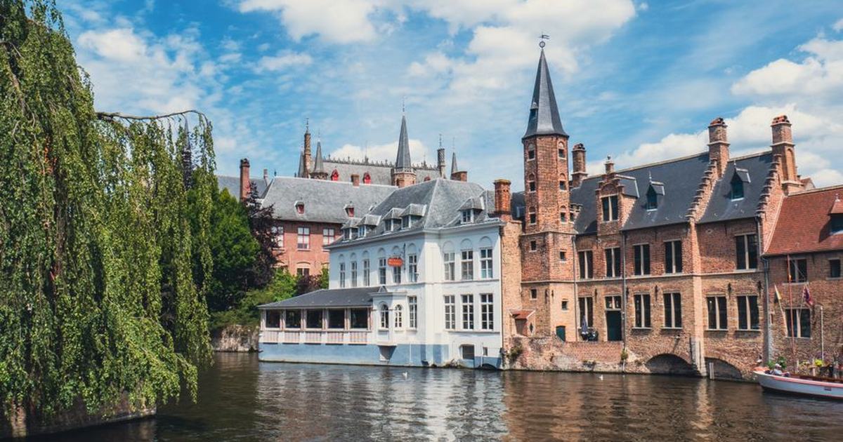Explore the picturesque canal and historical buildings in Bruges, showcasing timeless European architecture.